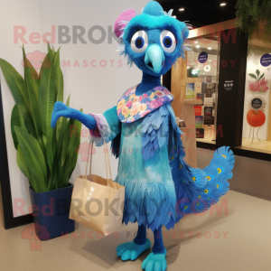Blue Peacock mascot costume character dressed with a Wrap Dress and Tote bags