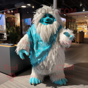 Turquoise Yeti mascot costume character dressed with a Poplin Shirt and Shawl pins