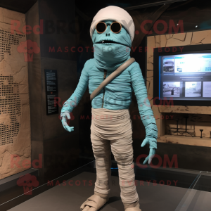 Cyan Mummy mascot costume character dressed with a Jacket and Suspenders