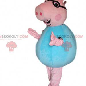 Mascote porco rosa com óculos e uma camisa azul - Redbrokoly.com