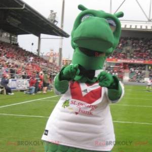 Groene draak dinosaurus mascotte met een sporttrui -