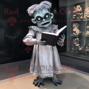 Silver Frankenstein'S Monster mascot costume character dressed with a Empire Waist Dress and Reading glasses