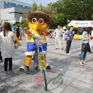 Grote bruine vogel mascotte met een kleurrijke outfit -