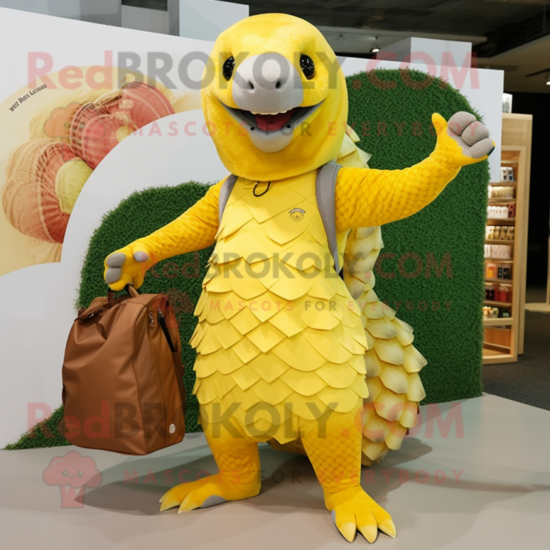 Lemon Yellow Pangolin mascot costume character dressed with a Board Shorts and Tote bags