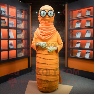 Orange Mummy mascot costume character dressed with a Maxi Dress and Reading glasses