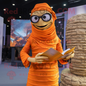 Orange Mummy mascot costume character dressed with a Maxi Dress and Reading glasses