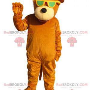 Oranžový medvěd maskot se žlutými slunečními brýlemi -
