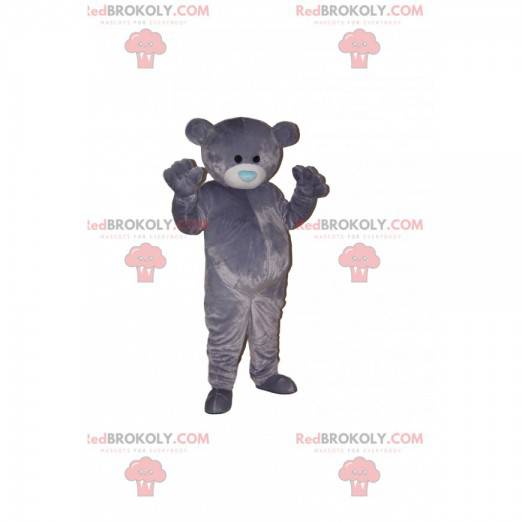Graues Bärenmaskottchen mit einer blauen herzförmigen Schnauze