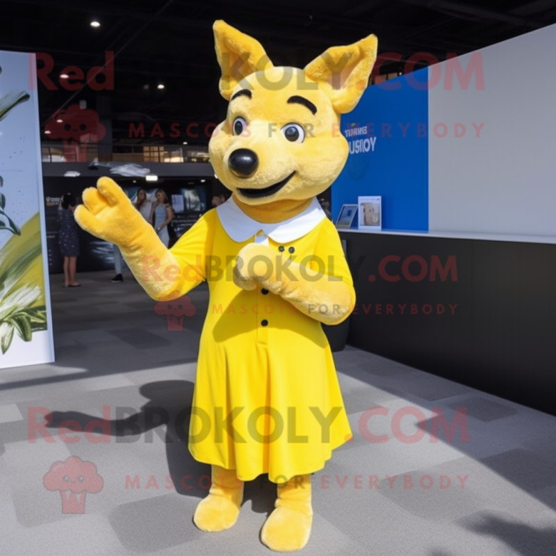 Lemon Yellow Dingo mascot costume character dressed with a Pleated Skirt and Mittens