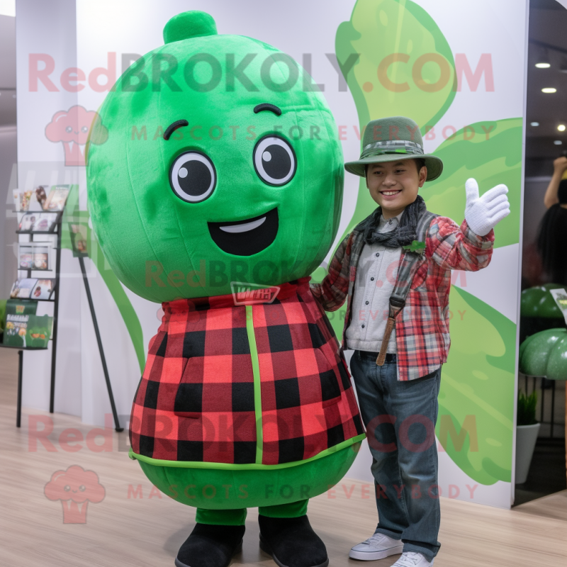 Green Watermelon mascot costume character dressed with a Flannel Shirt and Berets