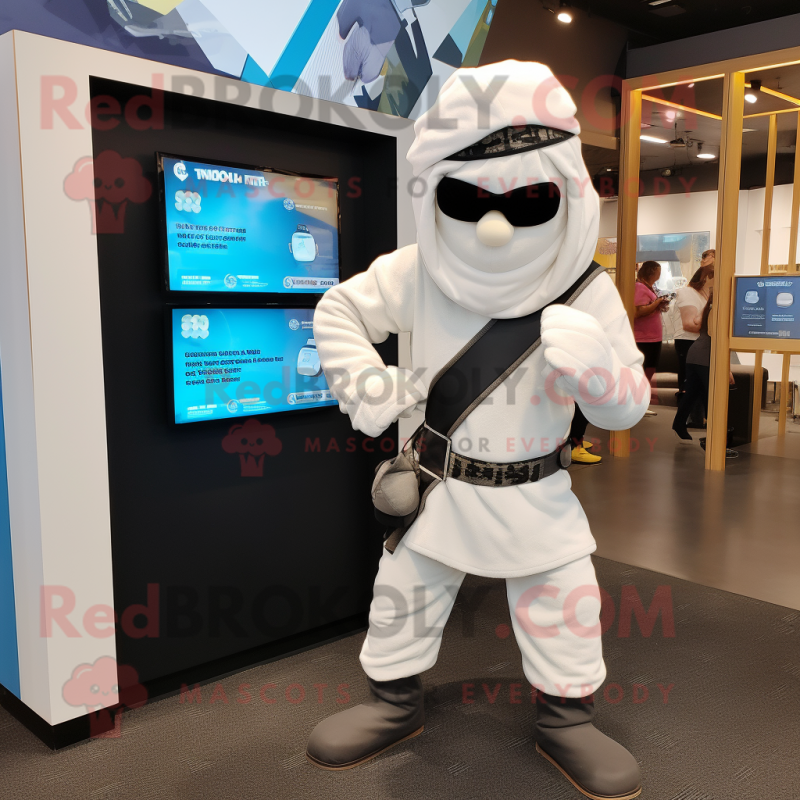 White Ninja mascot costume character dressed with a Flannel Shirt and Watches White Ninja mascot costume character dressed with a Flannel Shirt and Watches