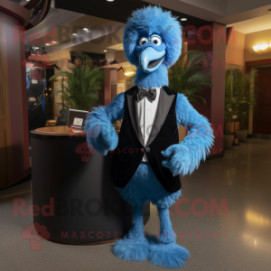 Blue Ostrich mascot costume character dressed with a Tuxedo and Clutch bags