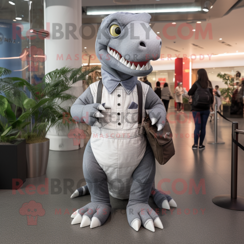 Silver Tyrannosaurus mascot costume character dressed with a Overalls and Clutch bags