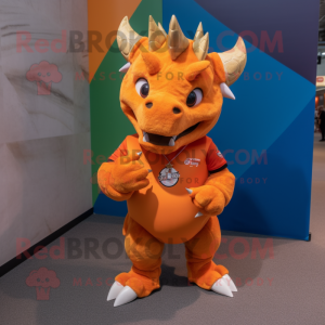 Orange Triceratops mascot costume character dressed with a Polo Tee and Rings