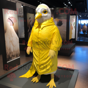 Lemon Yellow Pigeon mascot costume character dressed with a Coat and Wraps