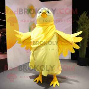 Lemon Yellow Pigeon mascot costume character dressed with a Coat and Wraps