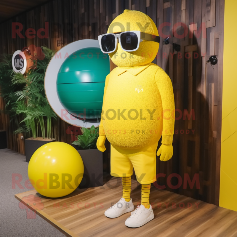 Yellow Golf Ball mascot costume character dressed with a Sweater and Sunglasses Yellow Golf Ball mascot costume character dressed with a Sweater and Sunglasses