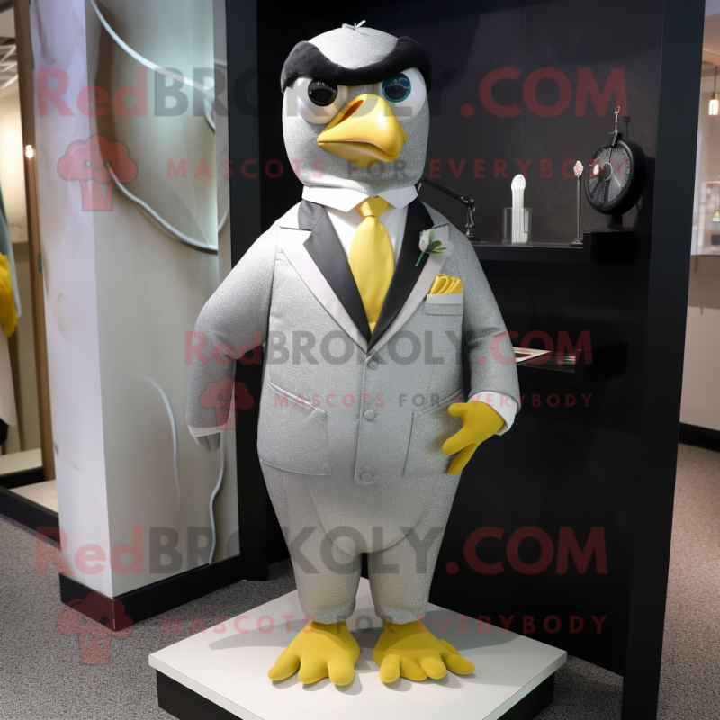 Silver Canary mascot costume character dressed with a Tuxedo and Tie pins