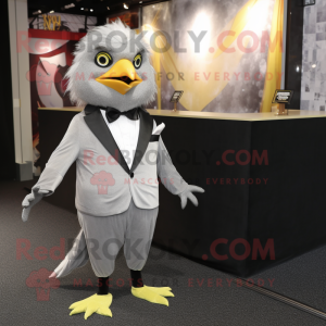 Silver Canary mascot costume character dressed with a Tuxedo and Tie pins