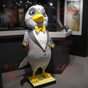 Silver Canary mascot costume character dressed with a Tuxedo and Tie pins