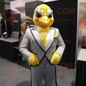 Silver Canary mascot costume character dressed with a Tuxedo and Tie pins