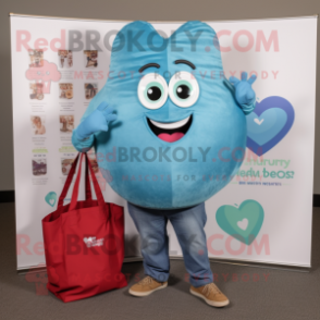 Turquoise Heart mascot costume character dressed with a Chambray Shirt and Tote bags