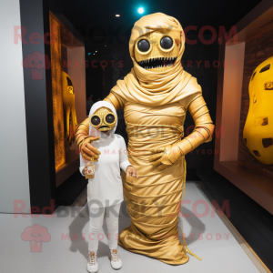 Gold Mummy mascot costume character dressed with a Mom Jeans and Rings