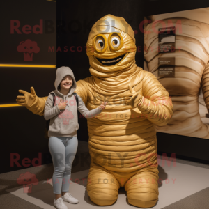 Gold Mummy mascot costume character dressed with a Mom Jeans and Rings