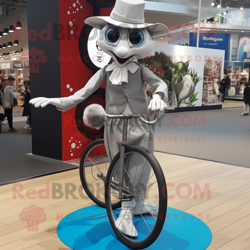 Silver Unicyclist mascot costume character dressed with a Oxford Shirt and Shawls