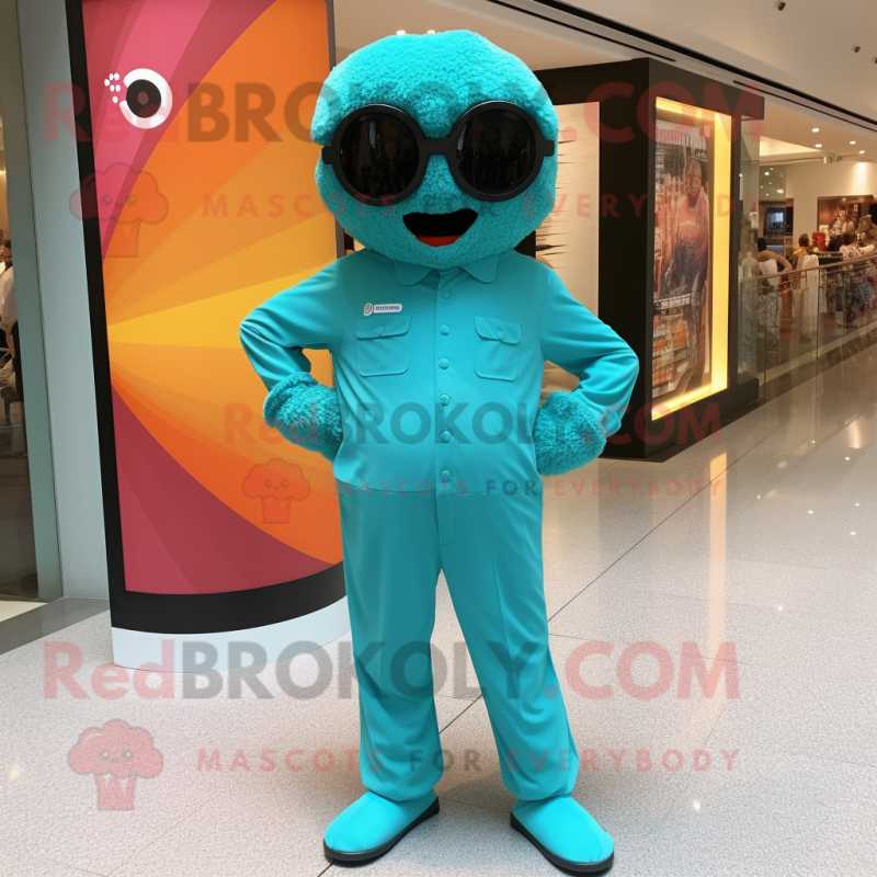 Teal Candy Box mascot costume character dressed with a Jumpsuit and Sunglasses Teal Candy Box mascot costume character dressed with a Jumpsuit and Sunglasses