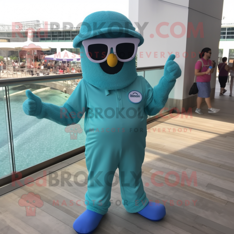 Teal Candy Box mascot costume character dressed with a Jumpsuit and Sunglasses Teal Candy Box mascot costume character dressed with a Jumpsuit and Sunglasses