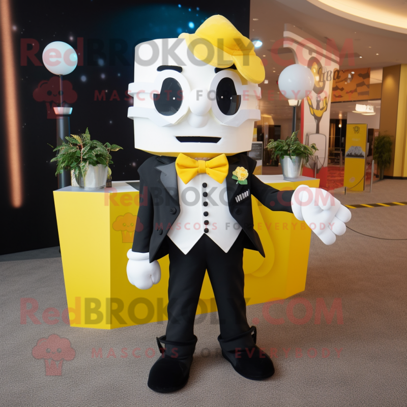 Yellow Pop Corn mascot costume character dressed with a Tuxedo and Backpacks Yellow Pop Corn mascot costume character dressed with a Tuxedo and Backpacks