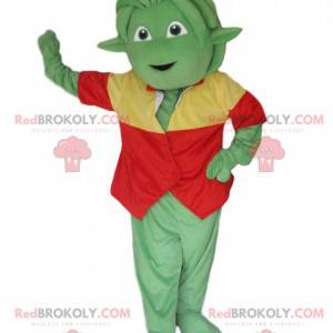 Mascotte creatura verde con una maglia rossa e gialla -