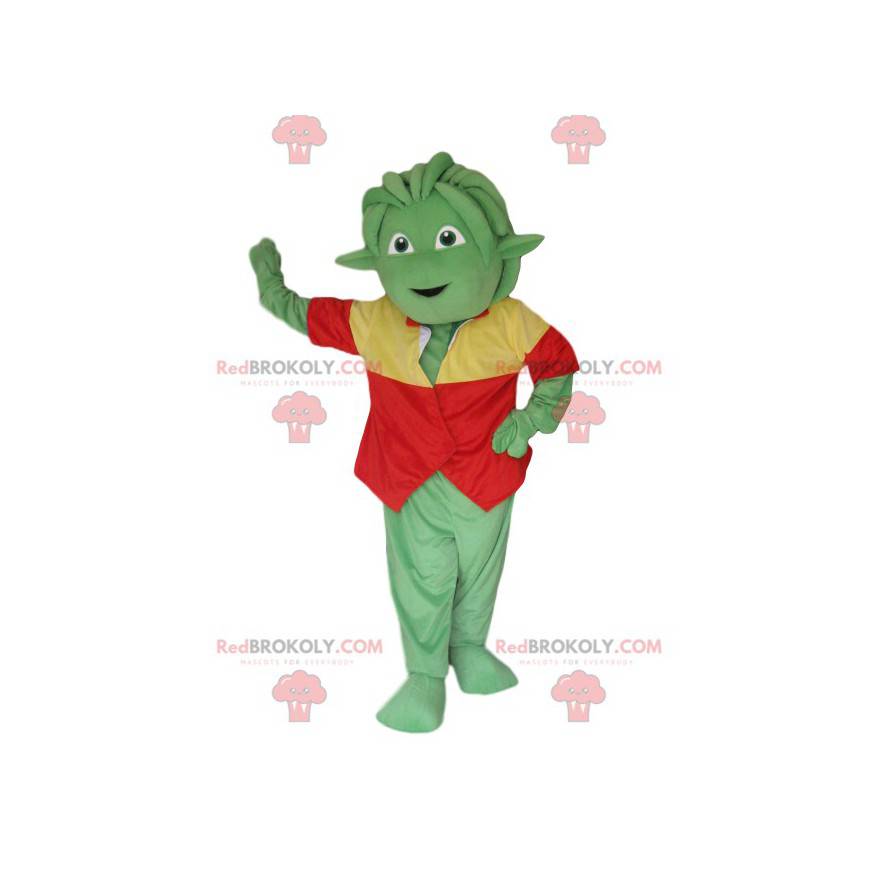 Mascotte creatura verde con una maglia rossa e gialla -