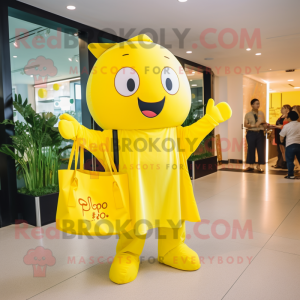 Yellow Pho mascot costume character dressed with a Graphic Tee and Tote bags