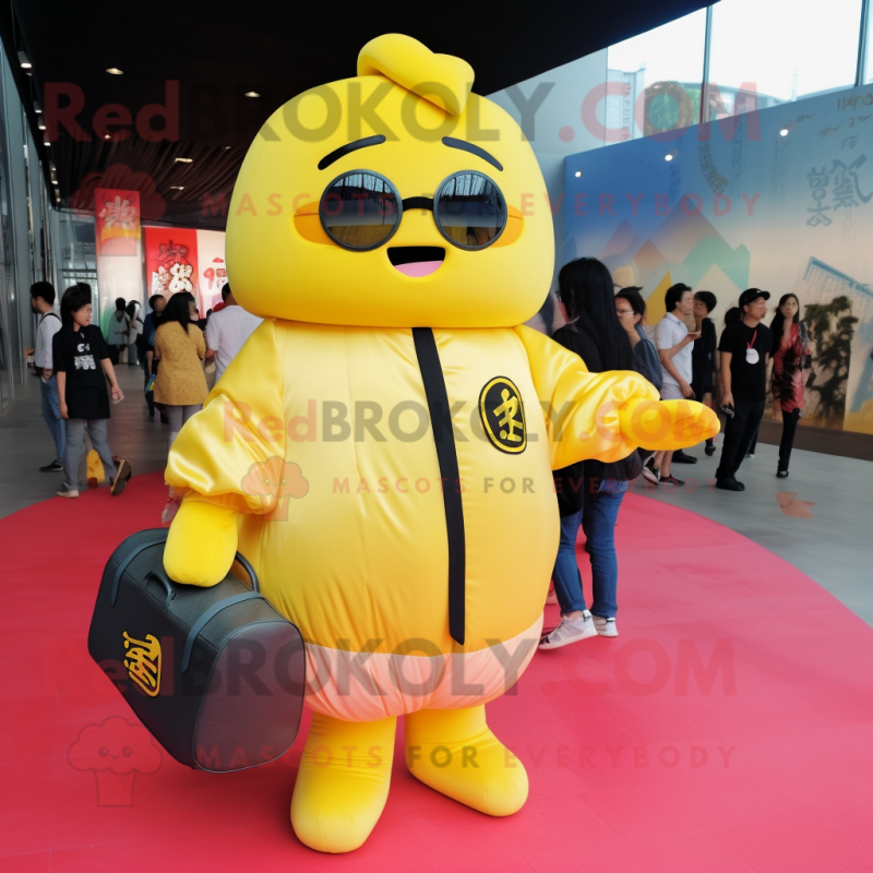 Yellow Dim Sum mascot costume character dressed with a Bomber Jacket and Messenger bags