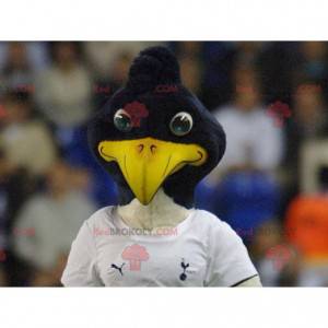 Mascote pássaro preto e branco em roupas esportivas -