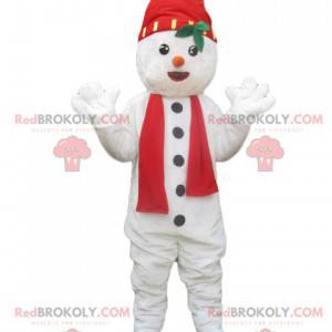 Sneeuwpopmascotte met een hoed en een rode sjaal -