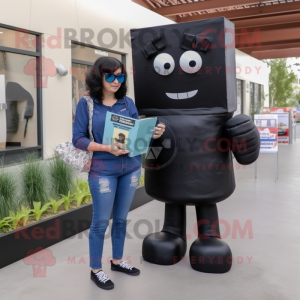 Black Candy Box mascot costume character dressed with a Mom Jeans and Reading glasses