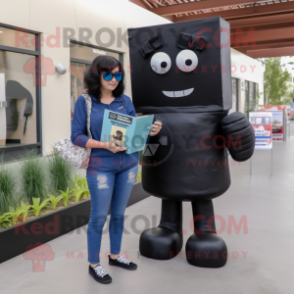 Black Candy Box mascot costume character dressed with a Mom Jeans and Reading glasses