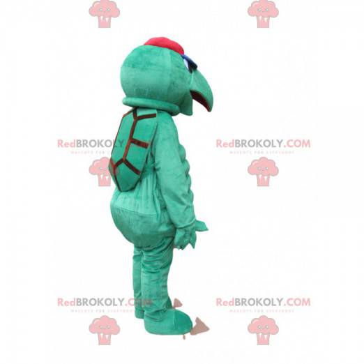 Green turtle mascot with a pointed muzzle and a cap -