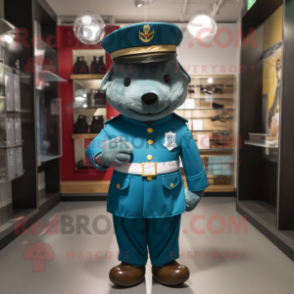 Teal British Royal Guard mascot costume character dressed with a Bomber Jacket and Hat pins