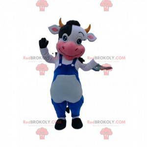 Mascota de la vaca en blanco y negro con un mono azul -