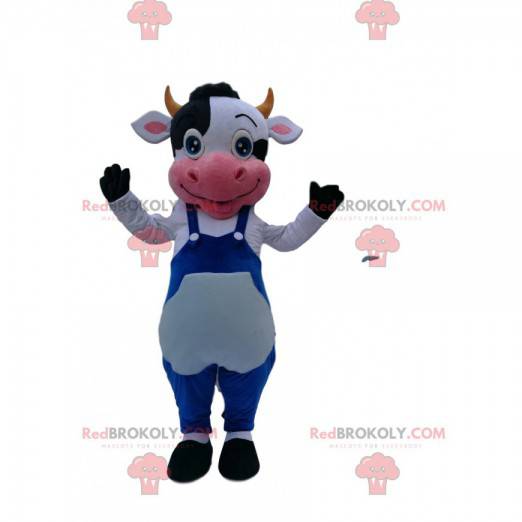 Mascotte de vache noire et blanche avec une salopette bleue -