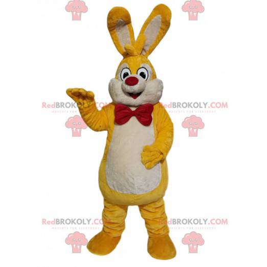 Mascote coelho amarelo e branco com um laço vermelho -
