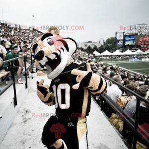 Mascote tigre bege e branco em roupas esportivas -