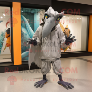 Gray Pterodactyl mascot costume character dressed with a Windbreaker and Foot pads