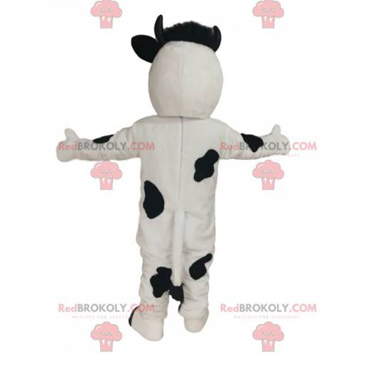 Mascotte della mucca in bianco e nero con un grande muso rosa -
