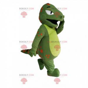 Mascota dinosaurio verde con puntos naranjas y burdeos -