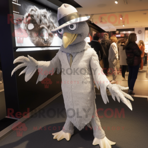 Silver Harpy mascot costume character dressed with a Coat and Hats